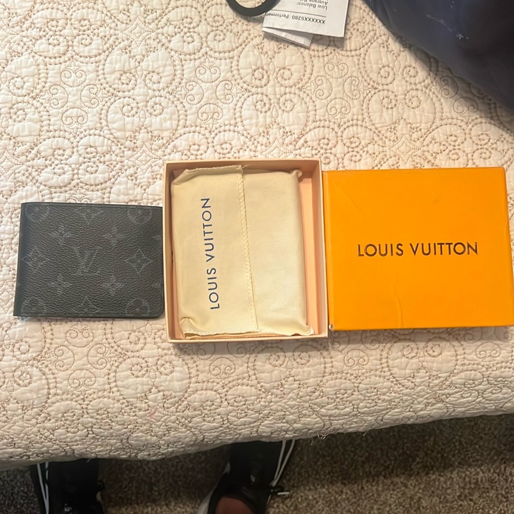 Louis Vuitton, wallet black and gray inside. Serial number is TR 3117.